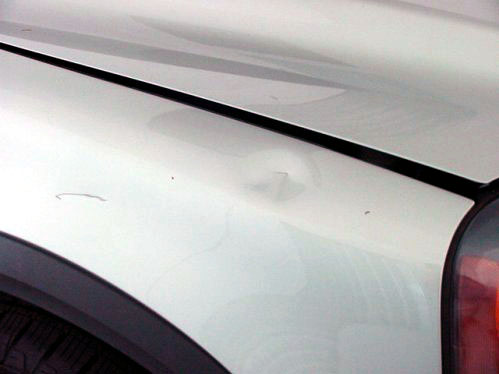 silver car fender damage before